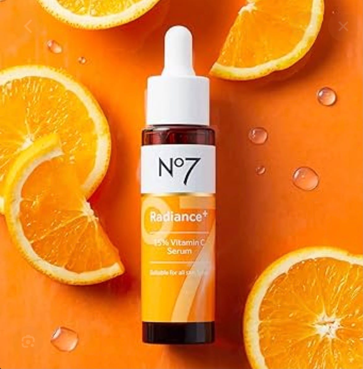 No7 Radiance+ vitamin C serum dropper bottle with fresh oranges