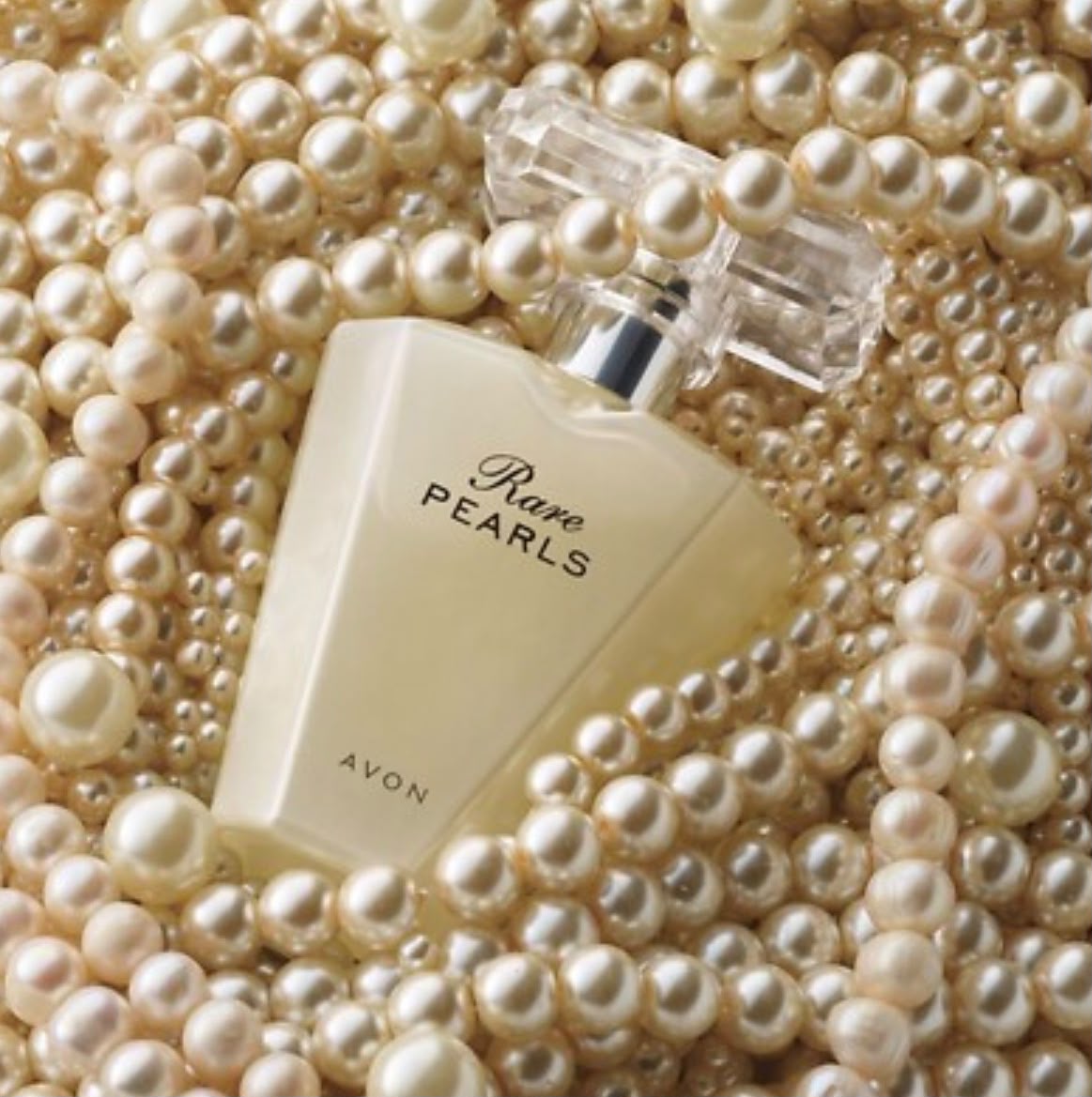 Avon Rare Pearls eau de parfum bottle resting on pearls