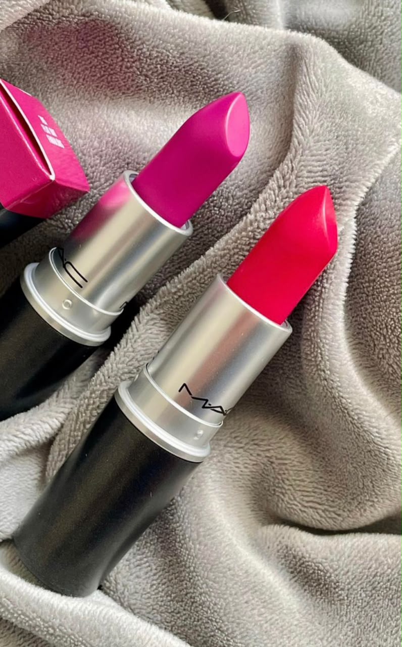 MAC lipsticks in pink and red shades on soft fabric